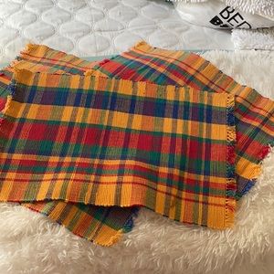Four cloth placemats.